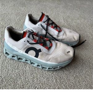 On Running Men’s White Running Shoes with Light Blue Soles and Red Accents